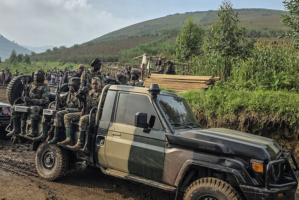  M-23 soldiers patrol near the scene of a landslide at an open pit coltan mine in Rubaya on January 30, 2026. The conflict in eastern DRC escalated in early 2025 as the M23 seized large swathes of territory and key cities. (Photo by AFP)