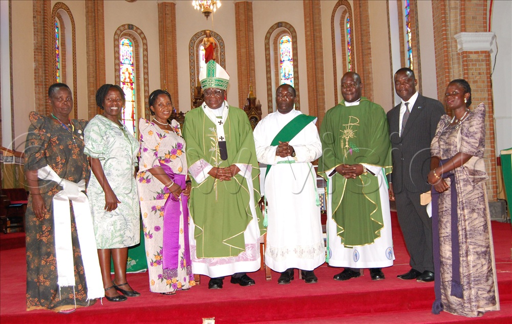 Archbishop Paul Ssemogerere (wearing a green chasuble and a mitre) shares a photo-moment with the Christian leaders from Ndeeba  parish during the SAAFU collection function at Lubaga Cathedral on Sunday, October 12, 2025. 