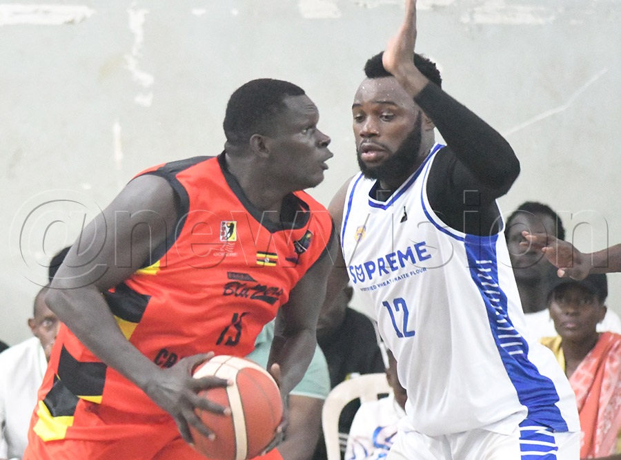 Nam Blazers Jimmy Okello (left) takes on City Oilers' Larry Ndikumana during Game-2 of the best of 7 FUBA league final playoff at Lugogo. Photo by Michael Nsubuga