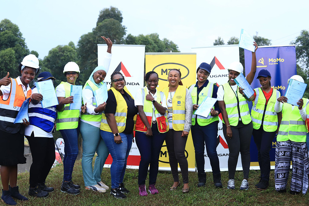 Dorothy Semanda, CEO at ATC Uganda (center) and Sylvia Mulinge, MTN CEO (5th from right) and some of the women supported in the first phase of the programme. (Photo by Ali Twaha)