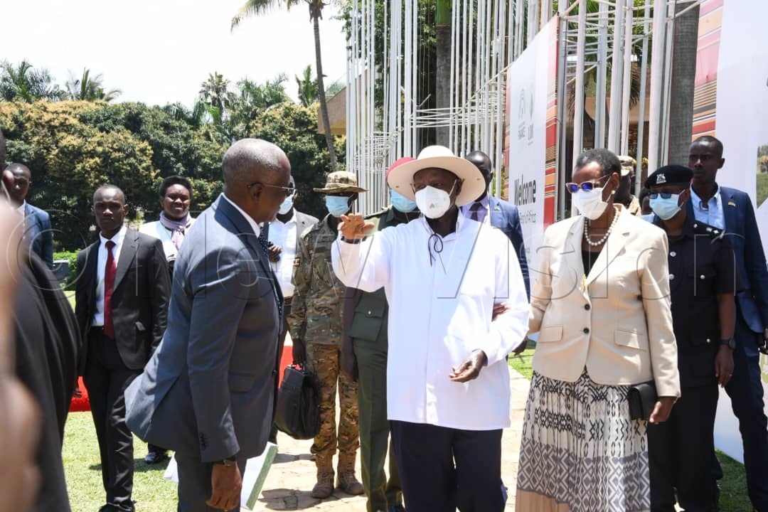 President Museveni accompanied by the First Lady and Minister of Education and Sports, Janet Museveni, waving to the delegates. 