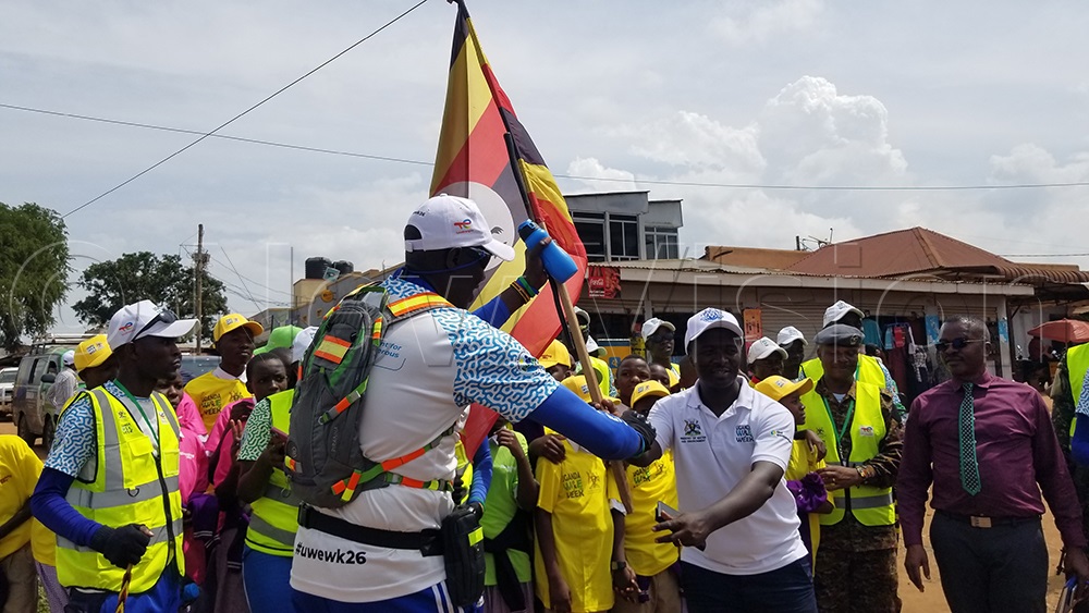 Eng. Maximo Twinomuhangi, in the company of Nabuyonga Primary School pupils and other Ministry of Water and Environment officials, welcomed Geofrey Ayene and other walkers into Mbale city. (Photo by Leonard Mukooli)