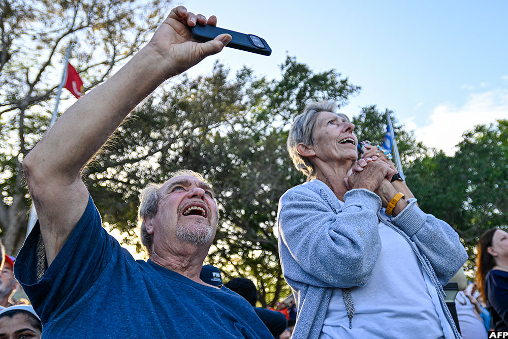 Space enthusiasts at a park in Titusville, view the Artemis II crewed lunar mission lift off
