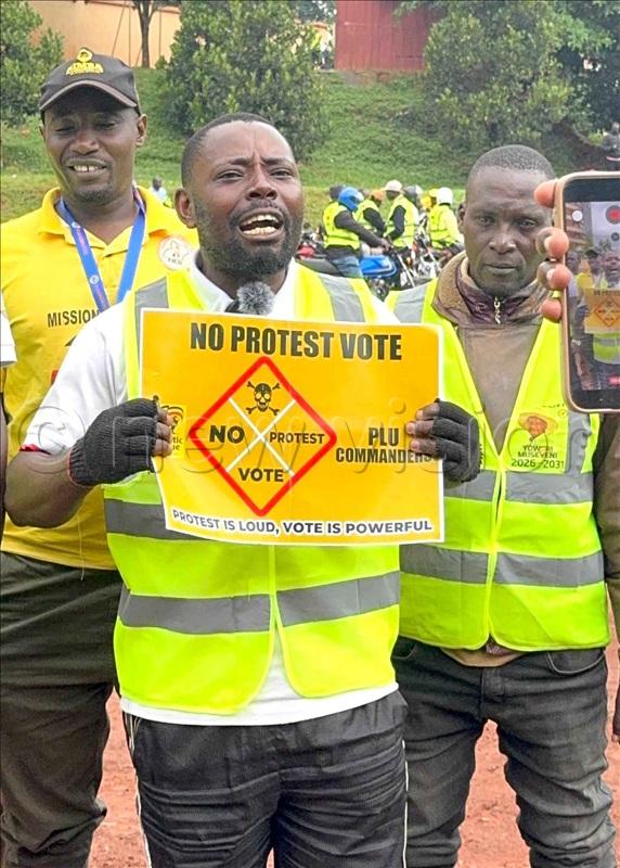 Edward Ssebulime alias Eddy Signal displays a placard in ant-protest vote campaign launch on Sunday December, 21 2025.