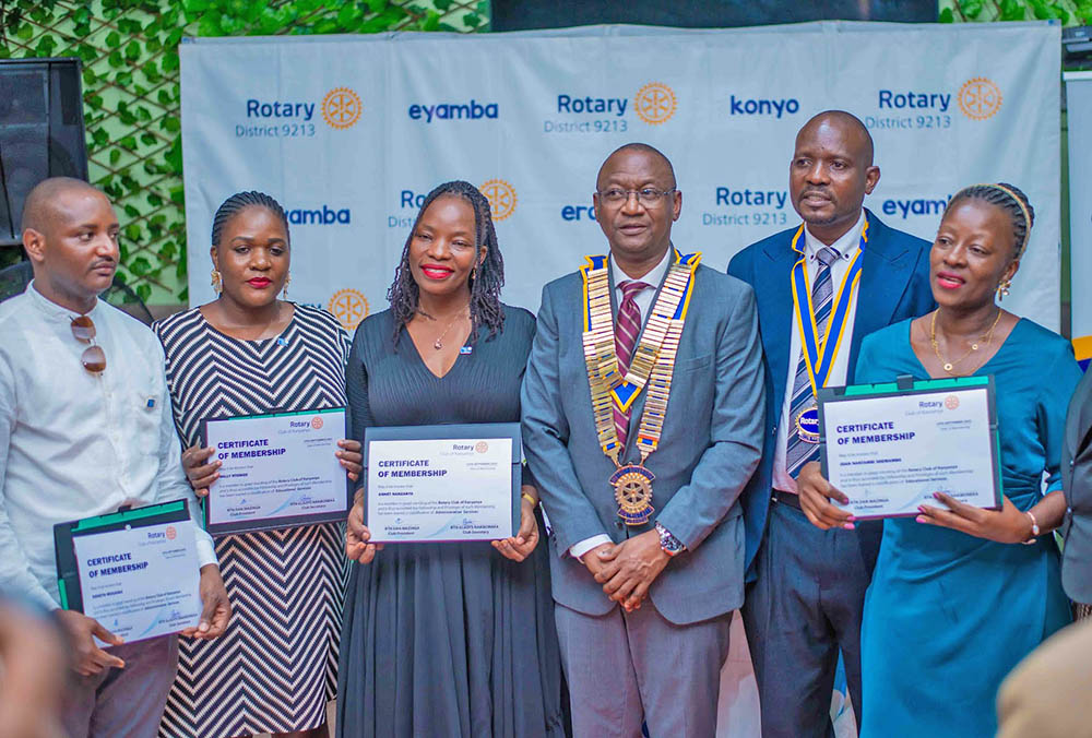 The District Governor (DG) of District 9213, Geoffrey Kitakule (3rd right) and Rotary Club of Kanyanya President, Dan Mazinga (2nd right) with new members Rotary Club of Kanyanya during an event held at Greenfield Gardens, Kanyanya. 
