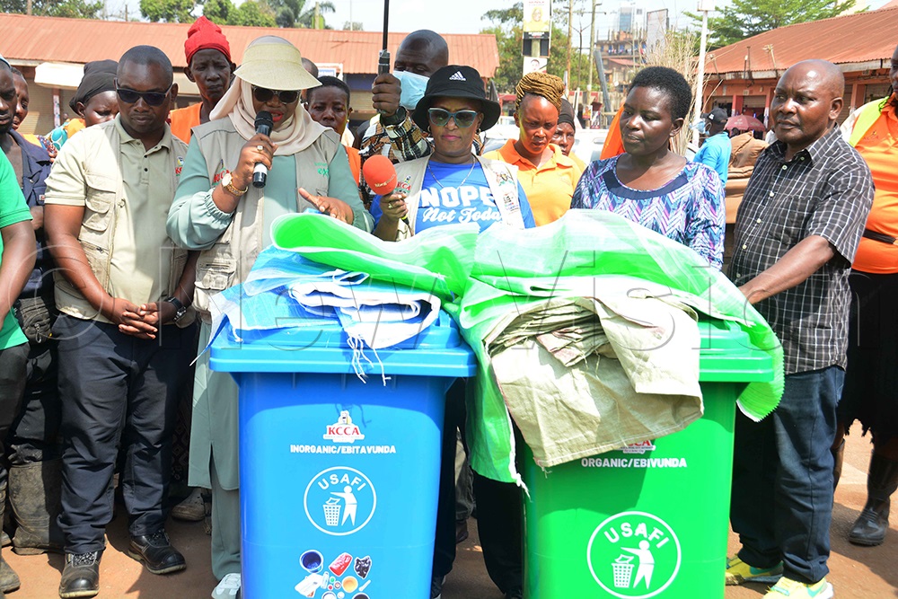 The KCCA executive director, Hajat Sharifah Buzeki (second left), explains the two types of skips for waste disposal, organic and inorganic, as the director of public health, Dr Sarah Zalwango (third left) and the mayor of central division, Douglas Nsubuga (left), look on after the cleaning exercise at Kisenyi III in Kampala on Saturday, November 29, 2025. (Photo by Francis Emorut)