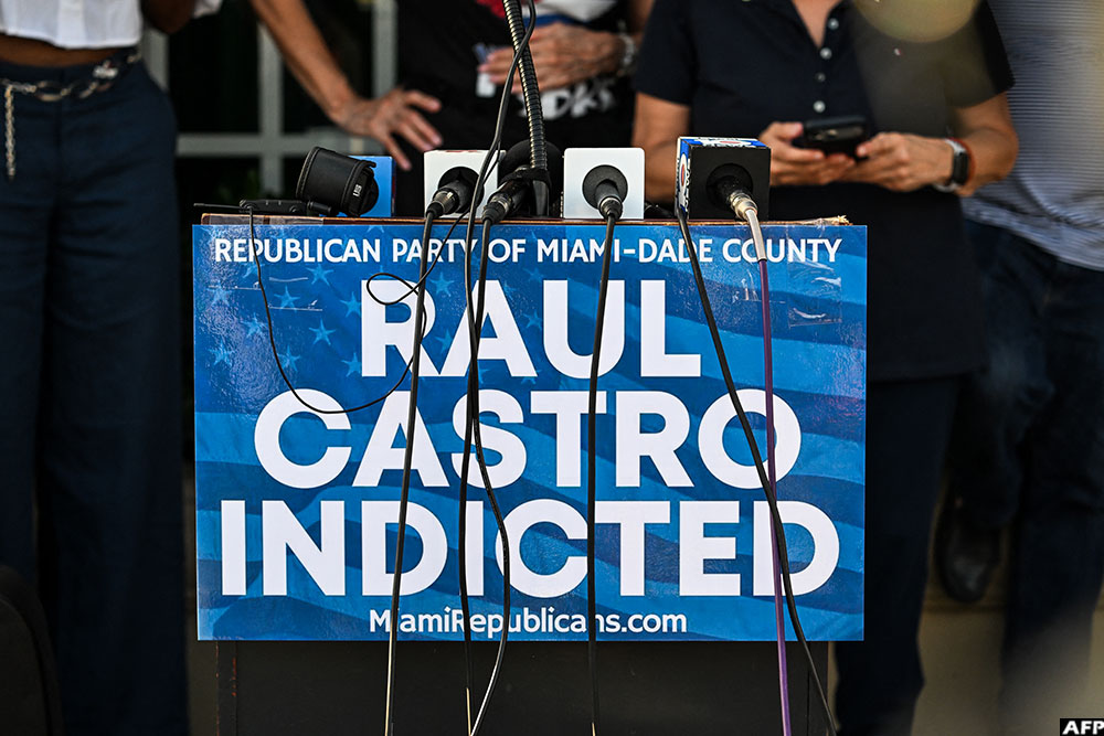 A sign on a lectern reads "Republican Party of Miami-Dade County, Raul Castro Indicted" as people gather outside Versailles Restaurant in support of charges announced by US federal prosecutors against the former Cuban president in Miami, Florida, on May 20, 2026. (AFP)