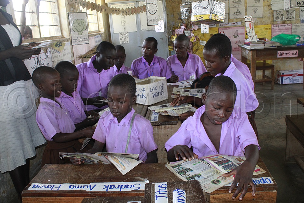 Pupils of Kamguru Primary School in Nwoya District read stories in Toto Magazine. (Photo by Ritah Mukasa)