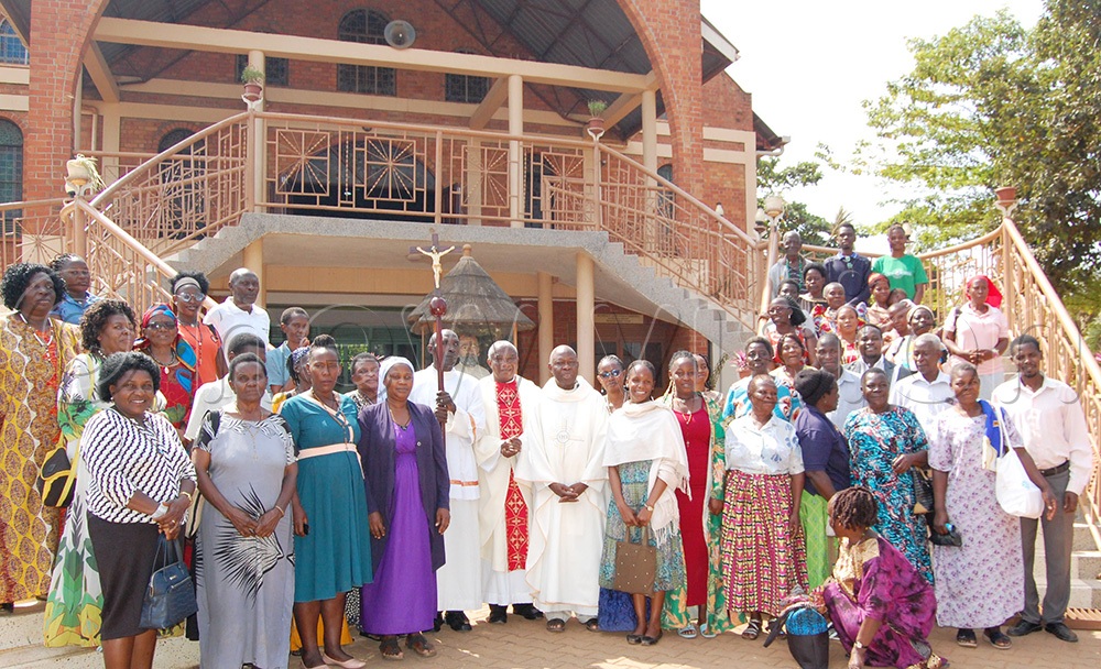 The Catholic faithful share a photo moment with the clerics after the Eucharistic celebration for the commemoration of the 147th anniversary of the dedication of Uganda to the Blessed Virgin Mary, by the White Fathers (Missionaries of Africa). The function took place at St. John the Baprist Mapeera-Nabulagala Catholic parish church, in Rubaga Division on Thursday, July 2, 2026. (Photo by Mathias Mazinga)