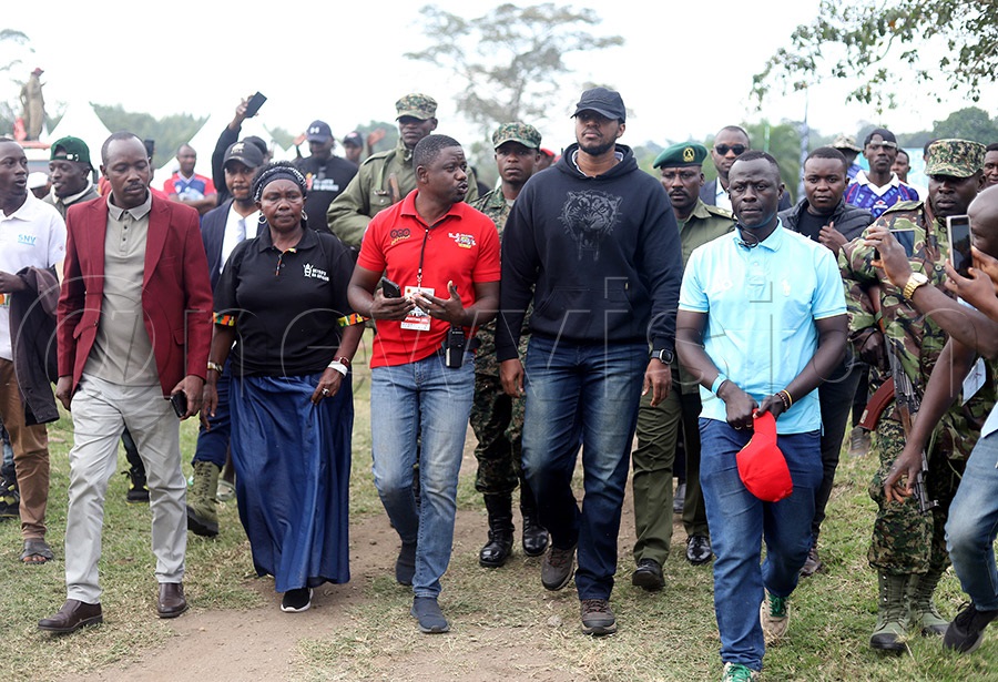 FMU General Secretary Reynold Kibira (left, in red) briefs the King of Tooro Kingdom about motorsport as journalist Stuart Kimera looks on. Photo: Johnson Were