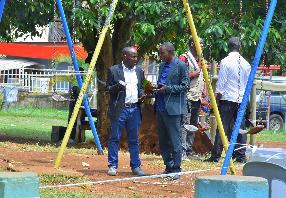 From a distance, DP candidate Shafiq Sserwadda (left) was sighted with NRM leaning independent Micheal Mutebi while monitoring several polling stations during the voting exercise in Entebbe municipality. (Photo by Julius Luwemba)
