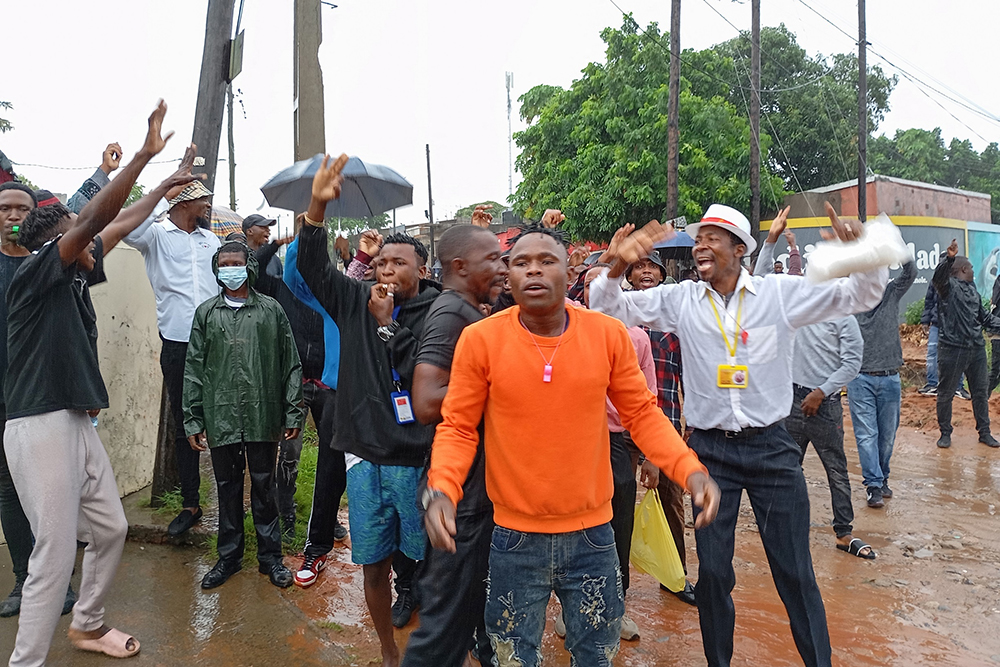 Supporters of Mozambique's opposition leader Venancio Mondlane gesture near a checkpoint as they try to get closer to the airport in Maputo on January 9, 2025. (AFP)