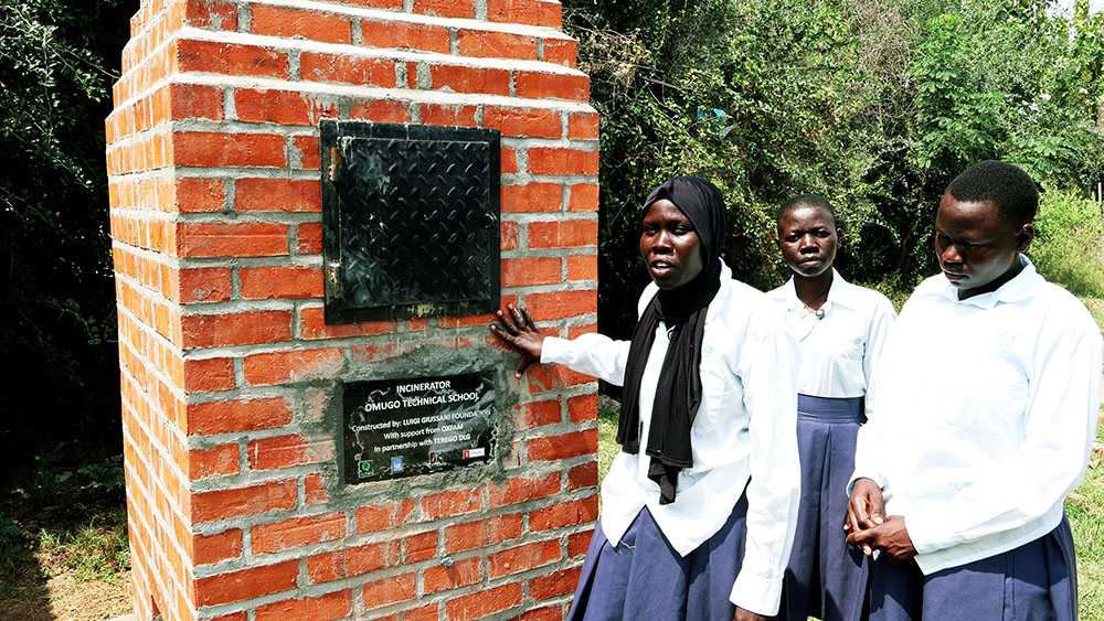 A section of girls from Omugo technical school explaining how the incinerator helps them to burn sanitary wears. (Credit: Geofrey Angupale)