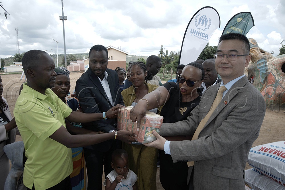 Zhang Zaoping, the Second Secretary at the China Embassy, accompanied by Finn Church Aid, UNHCR and OPM officials launch the China Emergency Humanitarian Assistance Project. (Photo by Abdulkarim Ssengendo)