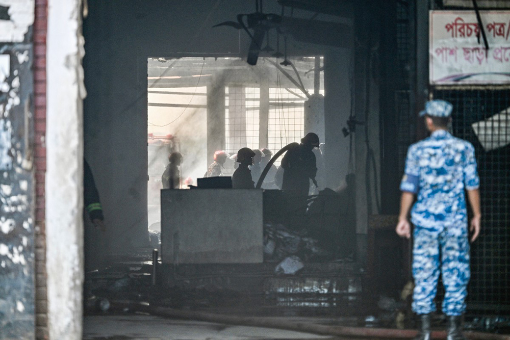Firefighters douse fire at the cargo terminal of Hazrat Shahjalal International Airport, a day after the blaze in Dhaka on October 19, 2025. A large fire swept through the cargo terminal of Bangladesh's main international airport in Dhaka on October 18, forcing authorities to suspend all flights, officials said.