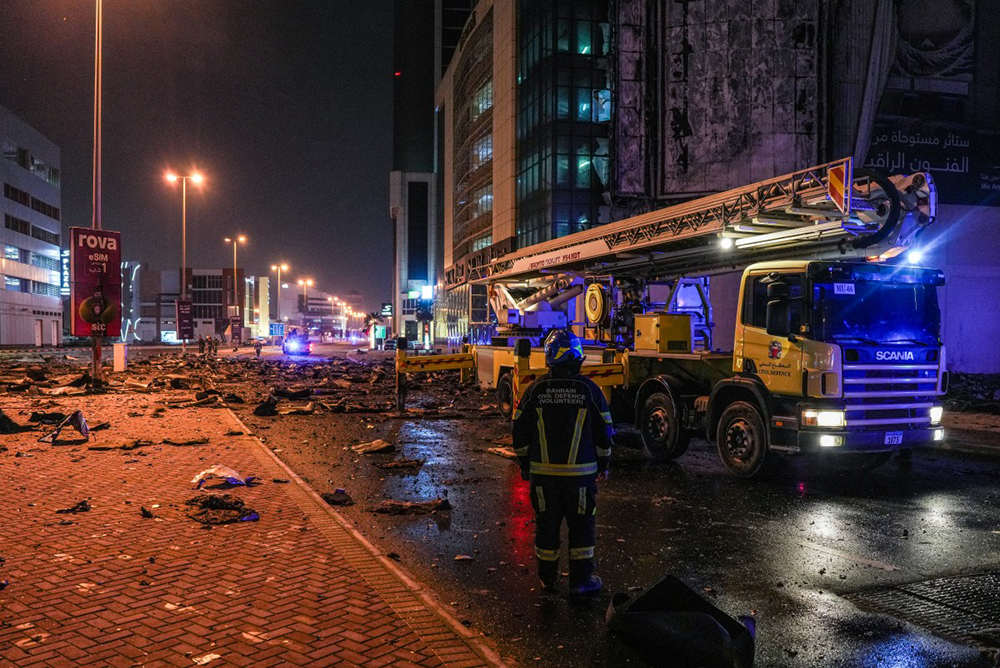 Emergency personnel work to extinguish a fire in a building after an Iranian strike in the capital Manama on February 28, 2026. (AFP)