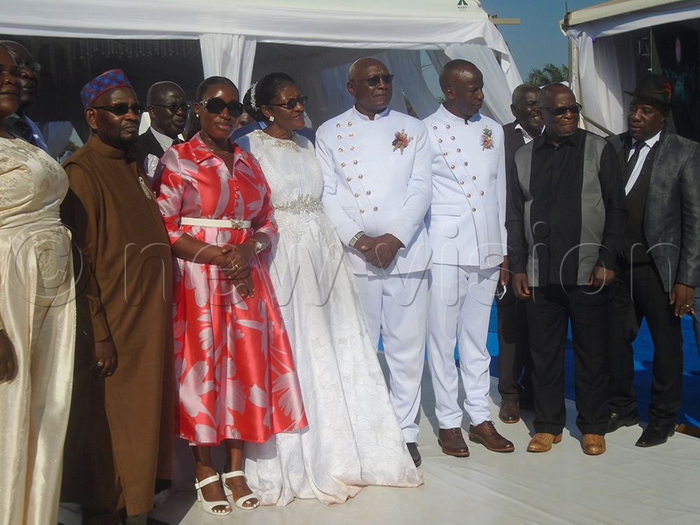 Bishop Sserwadda (4th right) wife Robinah Sserwadda (4th left), local government minister Justine Nameere (3rd left) and religious leaders at their 50th wedding anniversary. (Photo by Charles Kakamwa)