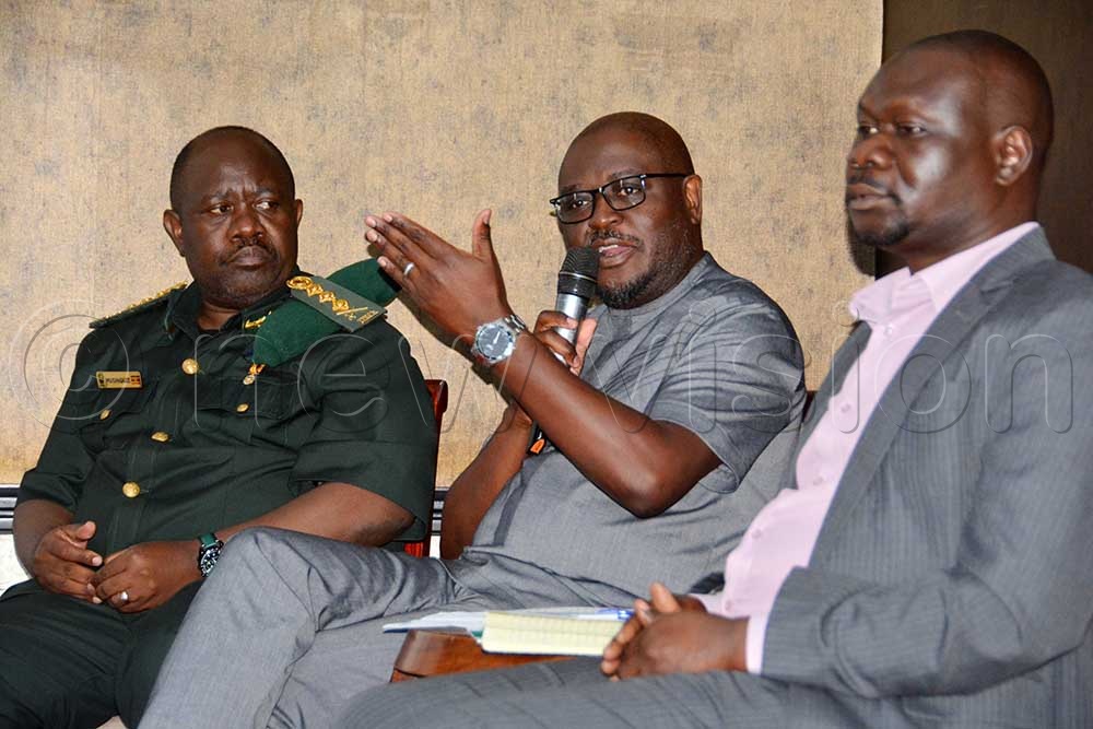 (L-R) Dr James Musingunzi executive director UWA, Solani Mhango director for Conservation Impact Africa WWF International display and Dr Ismael Ochen Ochen addressing participants during the launch of Wildlife Corridors in Greater Virunga Lansscape report at Kampala Sheraton Hotel. (Credit: Francis Emorut)