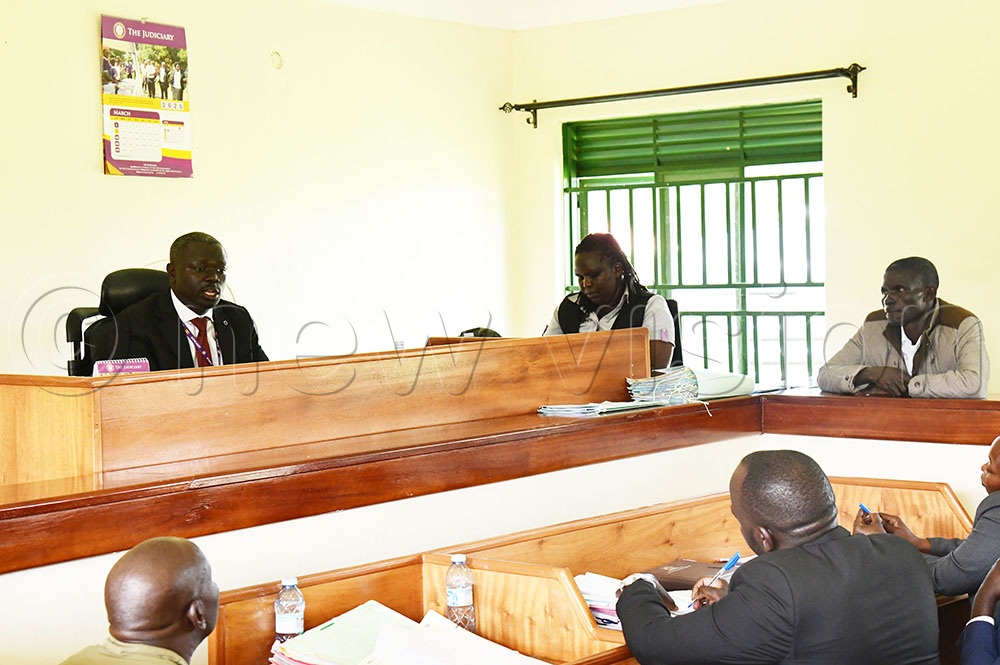 Grade one magistrate Edmond Okiror reading the judgement to Obany who was found guilty of electricity vandalism and illegal diversion of power. (Photo by Godfrey Ojore)