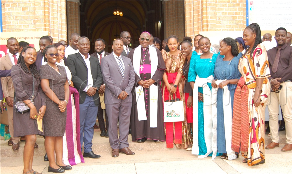 Archbishop Paul Ssemogerere (wearing a skull-cap and a white stole), Engineer Pius Mugalaasi (on the archbishop's immediate right) and Michael Ssebbowa Mukasa (on Mugalaasi's immediate right) share a photo moment with the Buganda Kingdom youth leaders during the pilgrimage and donors conference  at Lubaga Cathedral on Wednesday, October 15, 2025. 