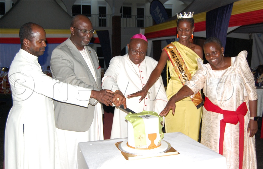 L-R: Fr. Dr. John Vianney Kitooro, Buganda's Deputy Katikkiro Robert Wagwa Nsibirwa, Archbishiop Paul Ssemogerere, Miss Tourism Uganda Nachap Cindy Kezia and Mrs. Annet Katende cut cake in celebration of the commissioning of Kabaka Muteesa I Catholic Memorial Museiun on October 25.