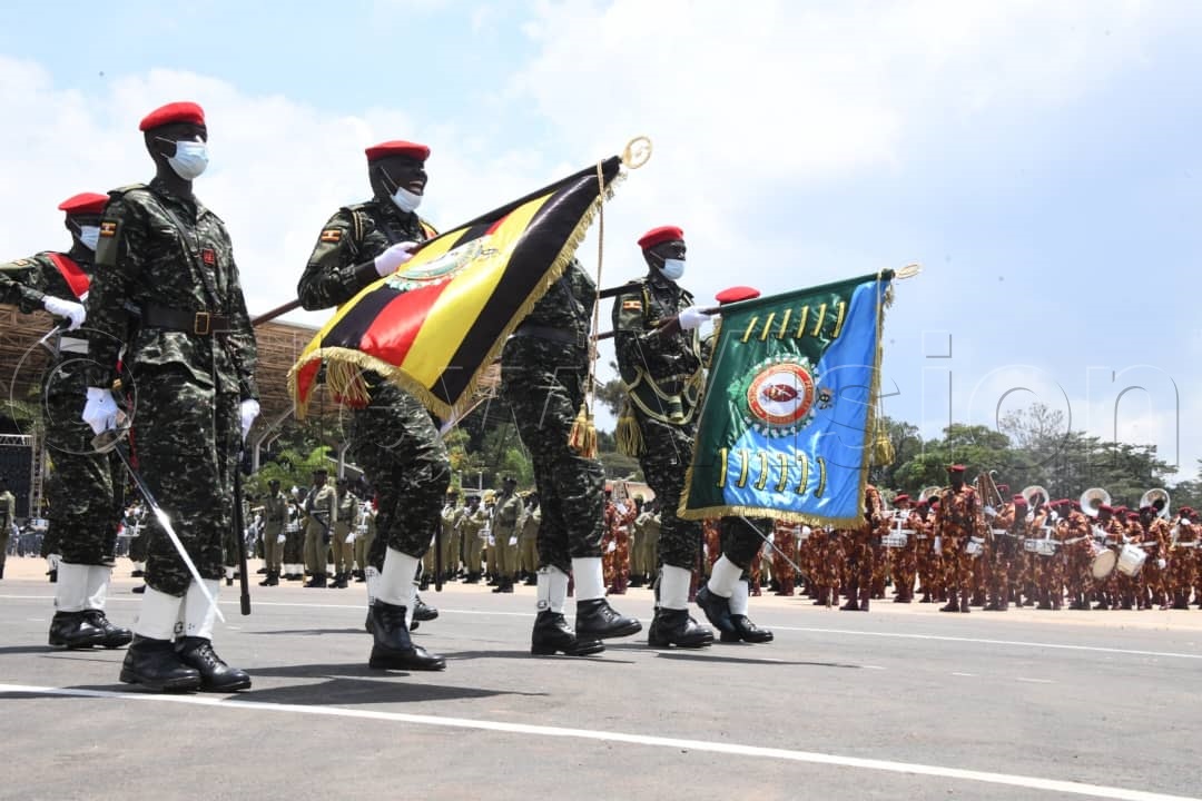 Soldiers holding the Uganda national flag and UPDF flag during the parade. 