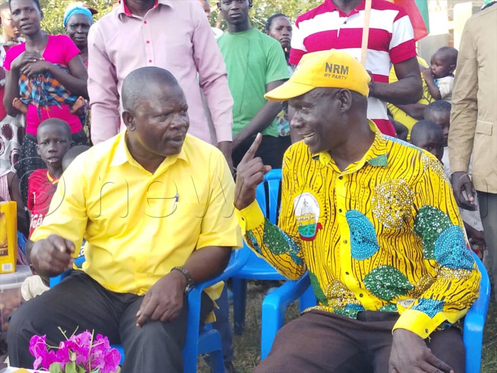R-L; Moses Oriada (in a cap), the LCV elect for Kalaki district having a light moment with minister Ongalo. (Photo Christine Itado)