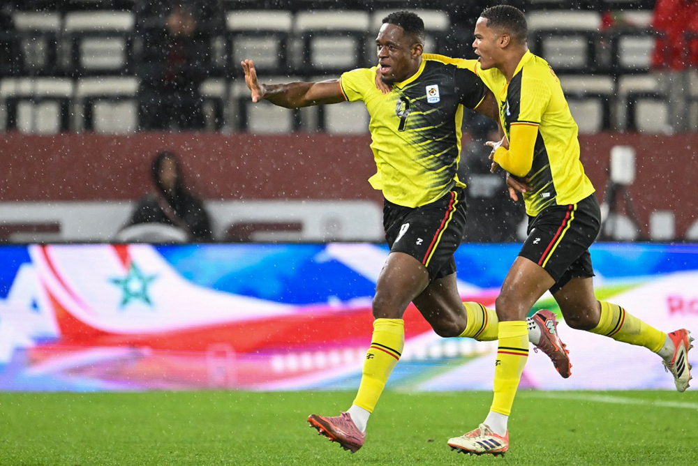 Uganda's forward #09 Uche Ikpeazu celebrates his goal with Uganda's defender #05 Toby Sibbick during the Africa Cup of Nations (CAN) Group C football match between Uganda and Tanzania at Al Medina Stadium in Rabat on December 27, 2025. (Photo by SEBASTIEN BOZON / AFP)