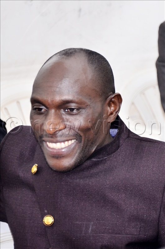 An aspiring presidential candidate Ntezibyayo Francis smile after receive an envelope contains nomination forms during pick of forms for presidential candidates at Electoral Commission offices in Kampala on 11 Aug 2025.