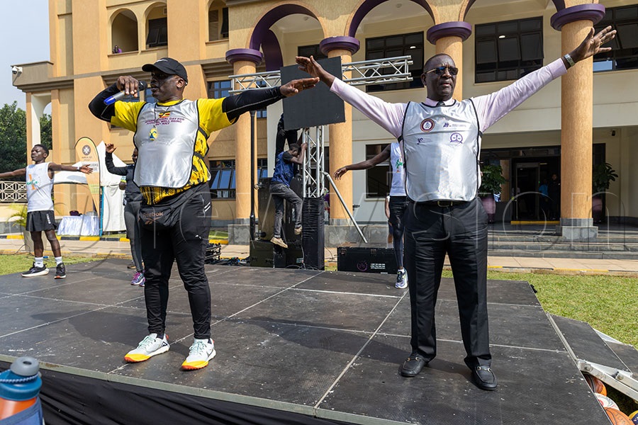 Coach Robert Ssebugwawo and the Permanent Secretary (PS) and secretary to the judiciary, Dr. Pius Bigirimanzi, demonstrate workout routines to judicial officers at the inaugural International Day for Judicial Well-being. Photo by Richard Sanya 