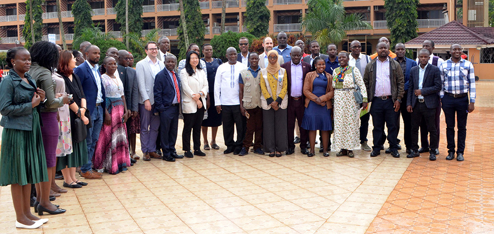 Dr. Henry Luzze,  Jihee Ahn KOICA Country Director and Dr. Achilles Katamba (C) and other guests take a photo after the dissemination meeting at Hotel Africana. (Photo by Violet Nabatanzi)