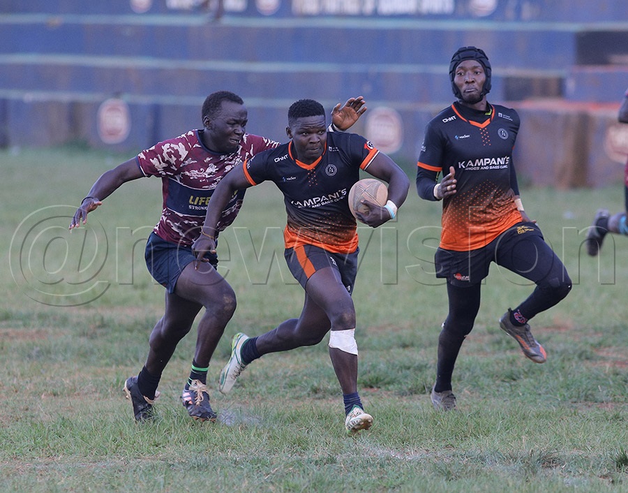 A Kampanis Eagle player with the ball breaks through the Rams opponent to score a try. PHOTOS: Johnson Were