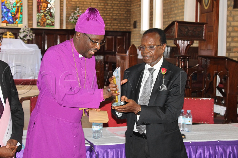Bishop Fred Sheldon Mwesigwa of Ankole Diocese appreciates Ambassador Francis Butagira for his 12 years of service as the diocese’s chancellor. (Photo by Abdulkarim Ssengendo)