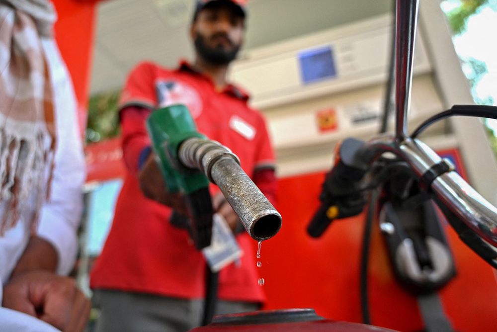 An employee fills the tank of a motorcycle at a fuel station in Islamabad on April 25, 2026 amid a rise in prices following energy supply disruptions due to war in the Middle East. (AFP)