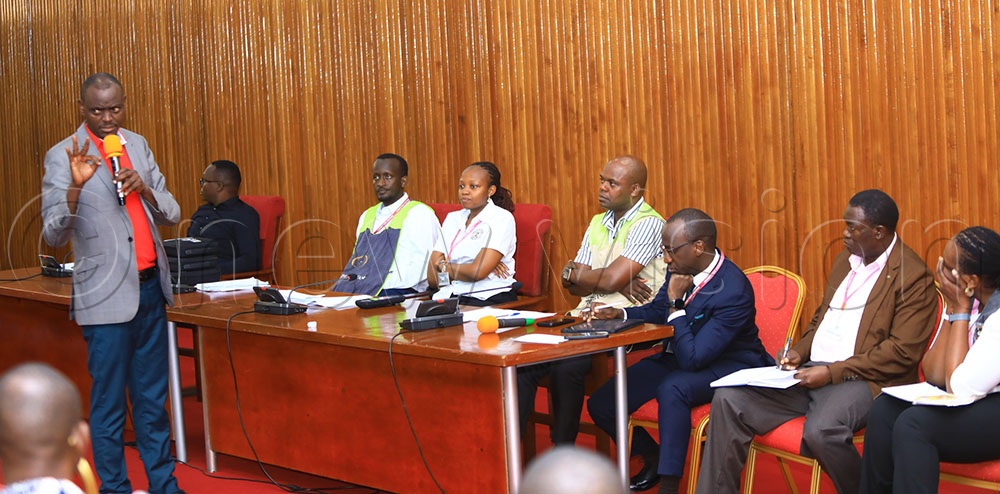 Ntenjeru South MP Patrick Nsanja, submitting as EC officials look on. (Credit: Dedan Kimathi)