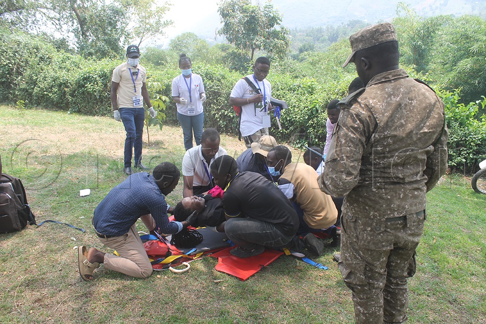 A team of 20 trainees performing an emergency and rescue drill after a seven-day training at the Rwenzori Mountains National Park headquarters. (Credit: Samuel Amanyire)