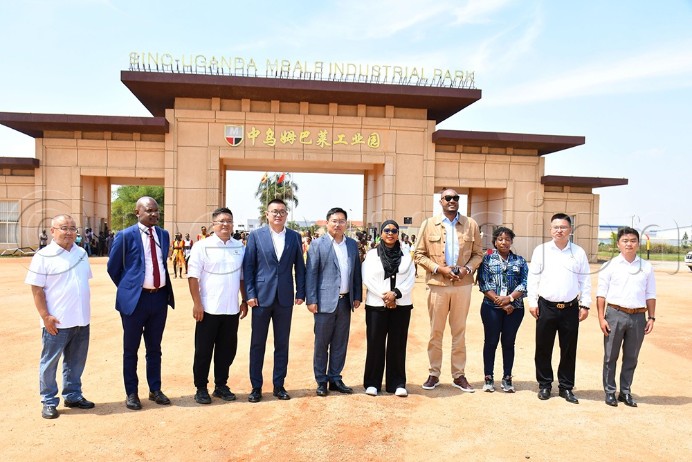 The Mbale Industrial Division Town Clerk Geoffrey Mugisha (2nd left), the Deputy Managing Director of Tian Tang Group Owen Jin (4th left), the Managing Director of Tian Tang Group Luke Wang (5th left), the State Minister for Privatisation and Investment, Hajjati Aminah Mukalazi (5th right) and Uganda Investment Authority's Director General Robert Mukiza (4th right) in a group photograph in front of the entrance of Sino-Uganda Mbale Industrial park on AugUst 26th. (Photo by Donald Kiirya)