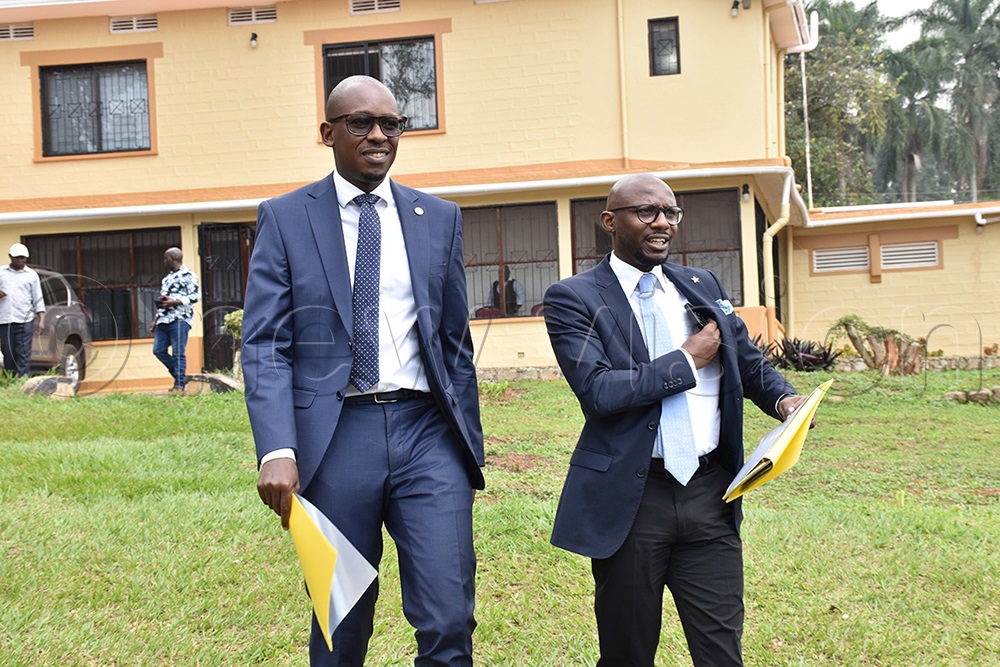 John Musiime (L) the NRM chairperson of the elections tribunal and Enoch Barata, the director legal for the NRM party arriving at the NRM legal offices on Kyadondo road for a press conference. (Photo by Simon Peter Tumwine)