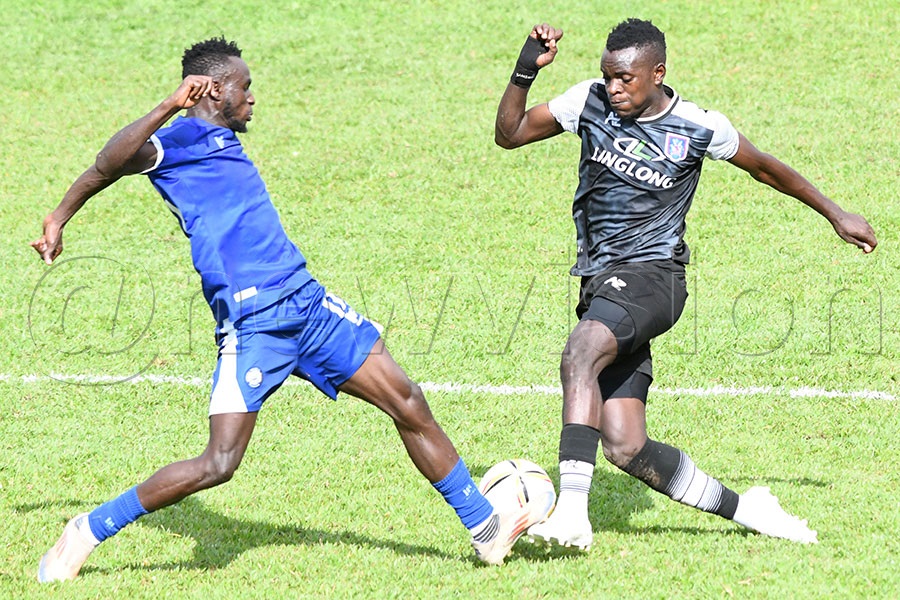 Police FC's Lawrence Tezikya (left) tackles SC Villa's S. Ssemayange during a Uganda Premier League match at Kira Police Ground.Photo by Michael Nsubuga