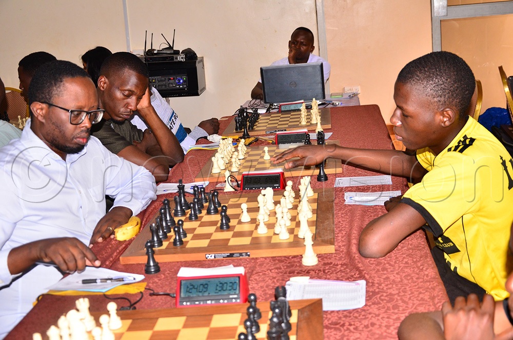 Harold Wanyama (L), Uganda's best chess player in East Africa, battling with Innocent Baguma, the National champion in Junior category, at the opening of the tournament in Jinja. (Photo by Jackie Nambogga)