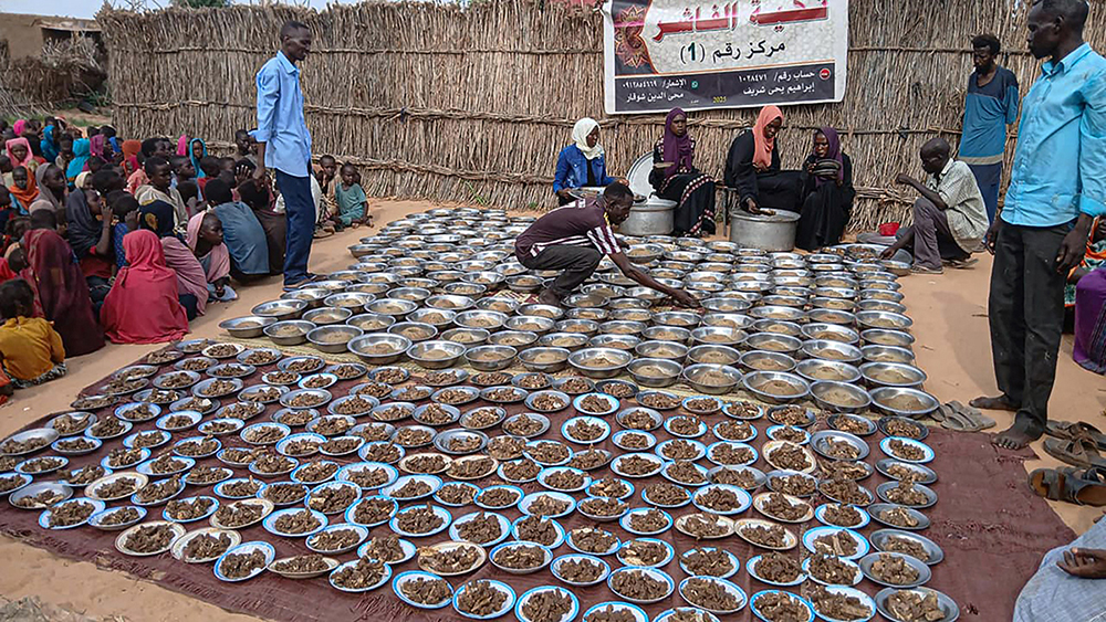 Sudanese volunteers prepare free meals for some of residents of Al Fasher, a city besieged by Sudan's paramilitary Rapid Support Forces (RSF) for more than a year, in Darfur region, on August 11, 2025. (Photo by AFP)