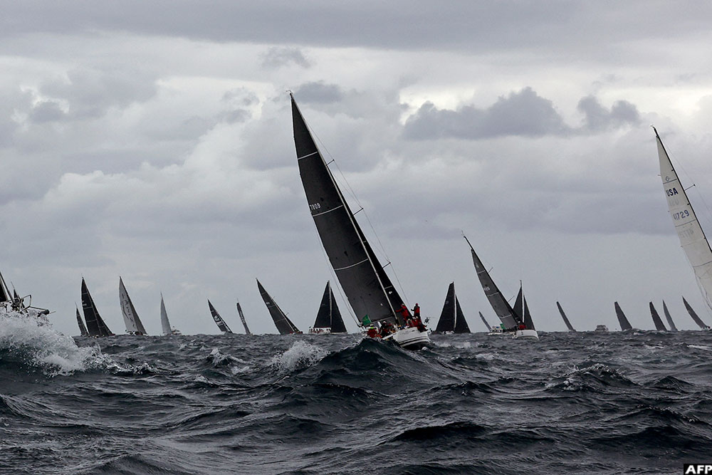 Yachts sail at the start of the annual Sydney to Hobart yacht race on Boxing Day at Sydney Harbour on December 26, 2025. (AFP)