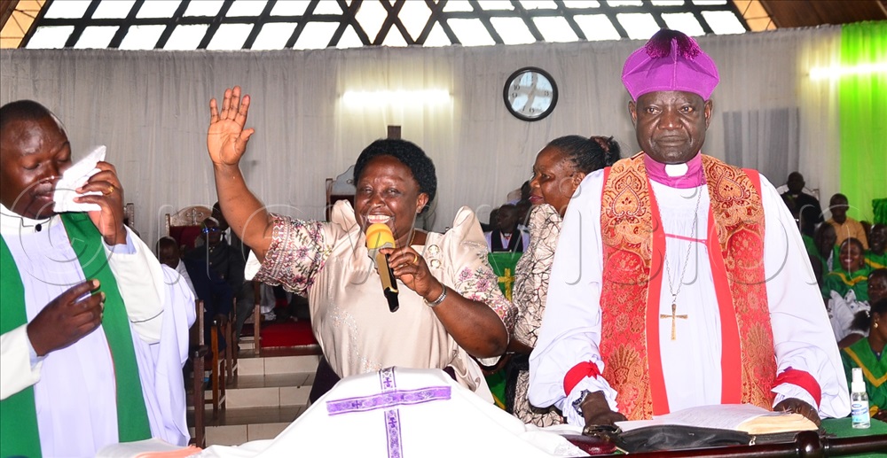 The assistant Vicar, the Rev. David Munobwa (left), Bishop of Busoga Diocese, the Rt Rev. Dr Paul Samson Naimanhye flanked by his wife Lydia bid farewell to the congregation at the cathedral on Sunday.