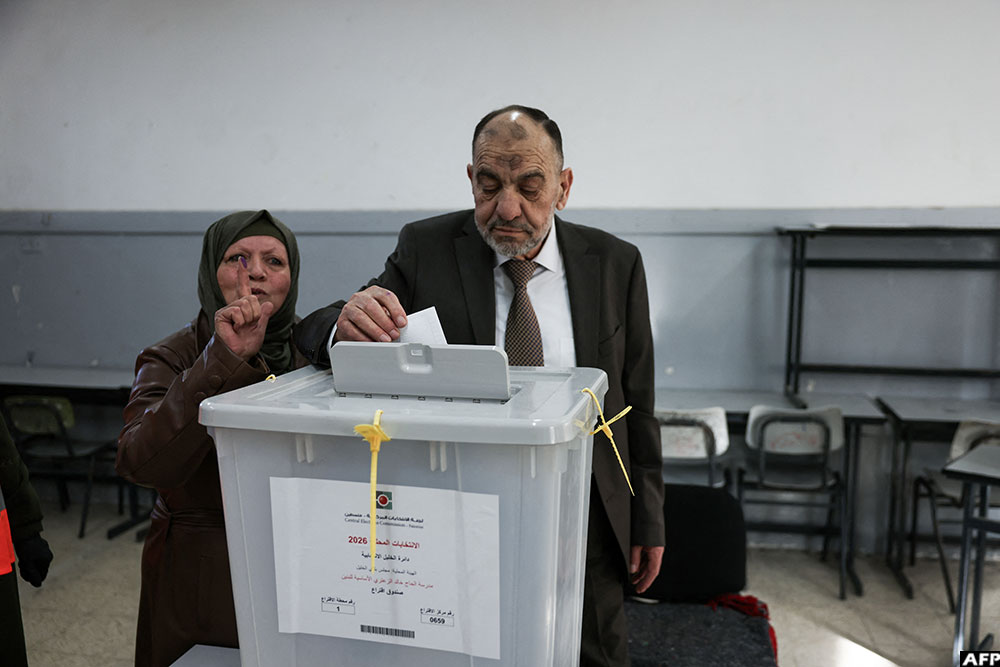 Mayor of Hebron Tayseer Abu Sneineh casts his ballot at a polling station during municipal elections in the Israeli-occupied West Bank city of Hebron on April 25, 2026.