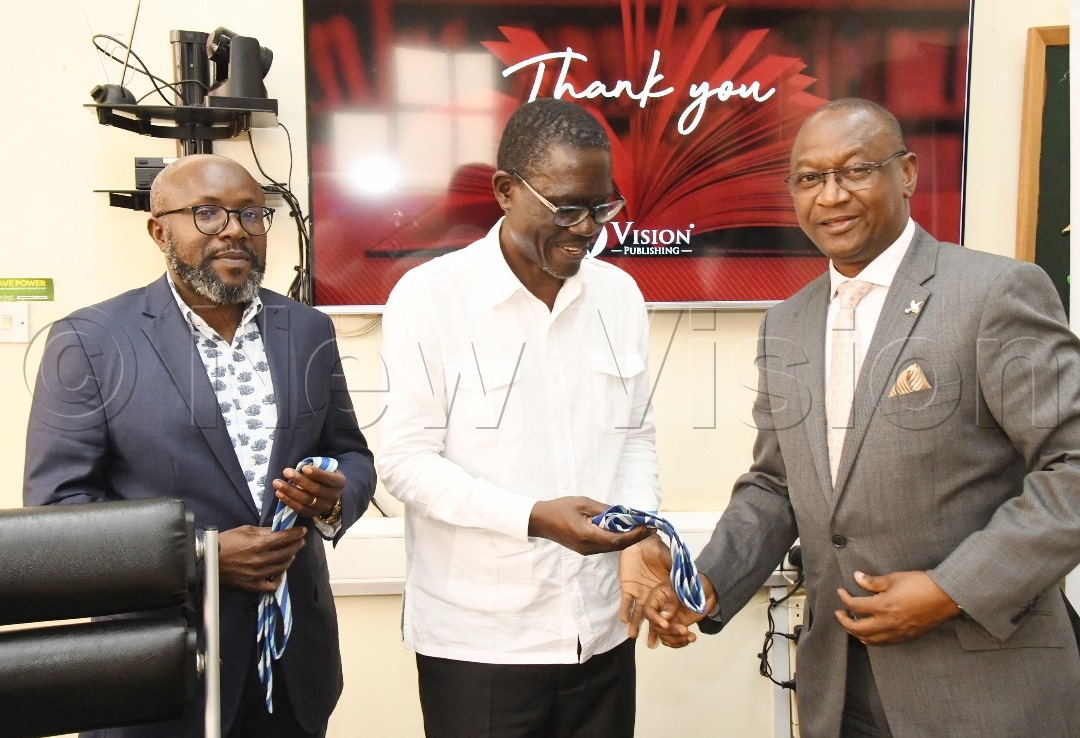 Geoffrey Martin Kitakule ,Rotary District Governor D9213 (right) gifts Vision Group CEO Don Wanyama (left) and Deputy EIC Felix Osike. (Credit: Mpalanyi Ssentongo)