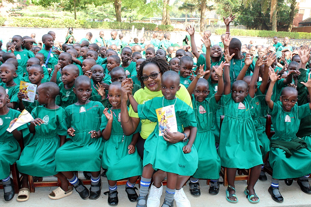 Grace Nampiima, the Editor of Toto magazine, having a moment with the Little ladies of Namugongo Girls Boarding Primary School. (Photo credit: Bridget Ahurira)