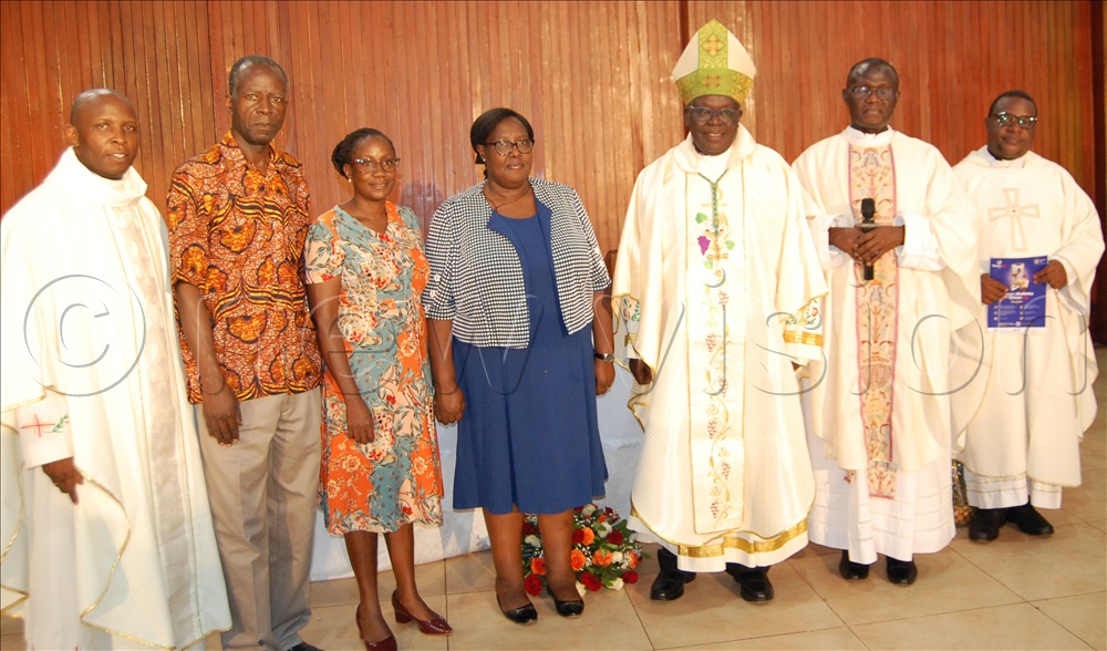 Archbishop John Baptist Odama (wearing a mitre) shares a photo-moment with the dons from Makerere University, who include Fr. Dr. John Bosco kamoga (left), Dr. Patrick Lumumba, Dr. Jacqueline Nakayiza and Dr. Charlotte Mafumbo.