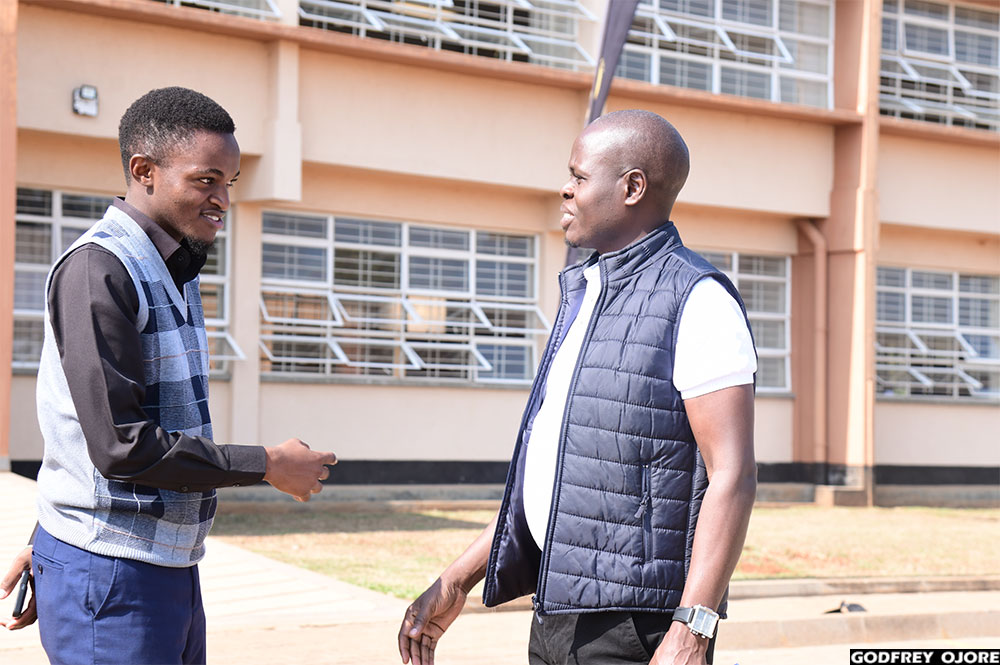 Aggrey Joshua Sikoria (left), a third year student of Busitema University and a participant in Season Three of the Ultimate University Quiz, welcomes Jonah Waiswa, the head of stakeholder engagement at Bank of Uganda, at the university's main campus for the quiz orientation